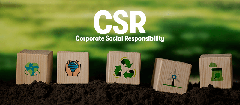 A picture of wooden block in soil, each with their own icon on the block. They have green energy, wind turbine, recycling symbol, the Earth, and a heart on the block. With the heading 'CSR Corporate Social Responsibility' above.