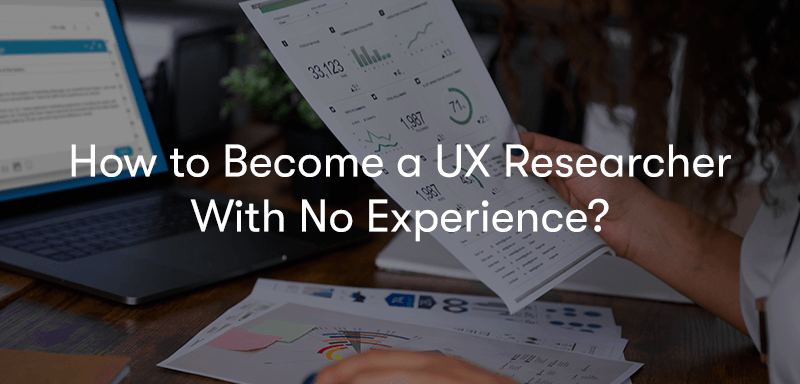 How to Become a UX Researcher With No Experience text in front of a person holding ux research on a piece of paper in front of a laptop on a desk