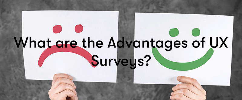 What are the Advantages of UX Surveys? text in front of hands holding up two pieces of paper, one with a red sad face and the other with a green happy face
