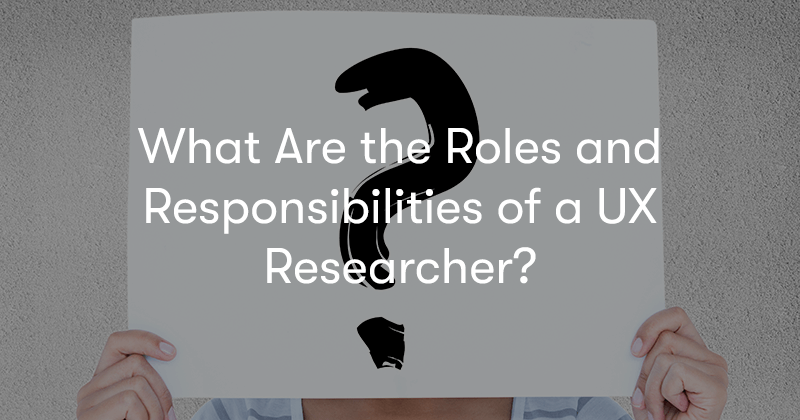 Hands holding up a piece of paper with a question mark drawn on, with the words What Are the Roles and Responsibilities of a UX Researcher? in front