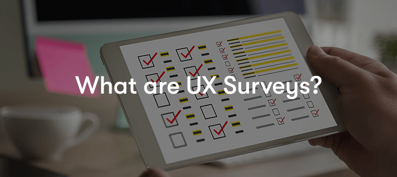 What are UX Surveys? text in front of a hand holding a tablet with a survey on it at a desk