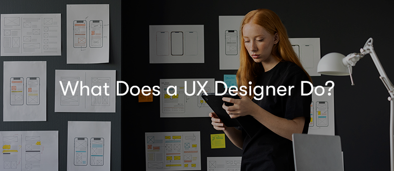 a picture of someone working at a desk with a stylus on a touch pad working. with the words 'What does a UX designer do?' in front.