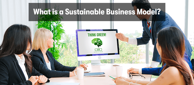 A picture of business people sat around a desk looking at a screen with think green on it. With the heading 'What is a Sustainable Business Model?' above.