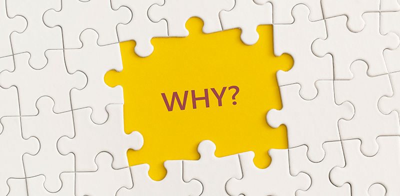 A picture of a white jigsaw puzzle, with one piece missing, revealing a yellow background with the text 'Why?'